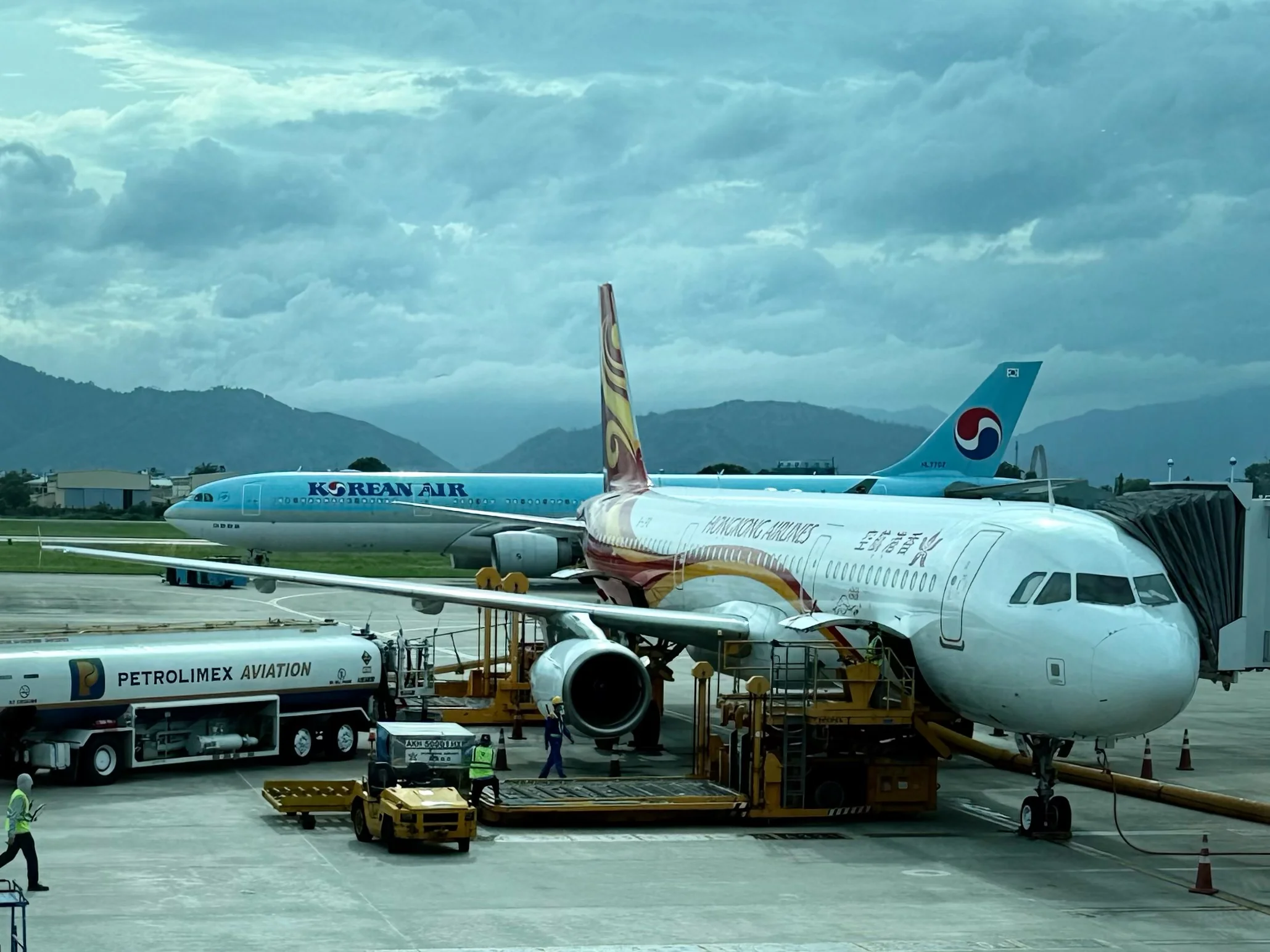 Da Nang International Airport tarmac with Hong Kong Airlines and Korean Air planes - the preferred entry point for worldschooling families visiting Hoi An